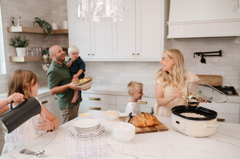 Allyse Jackson, founder of Beehive Meals, and her family prepping a Beehive Meal for dinner together in her kitchen.