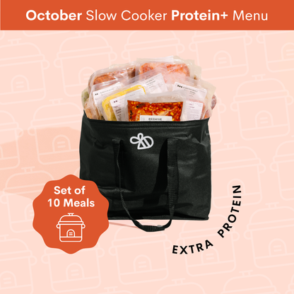 A black insulated slow cooker bag filled with packaged protein meals, shown on a pale pink patterned background with promotional text reading 'October Slow Cooker Protein+ Menu' and 'Set of 10 Meals'.