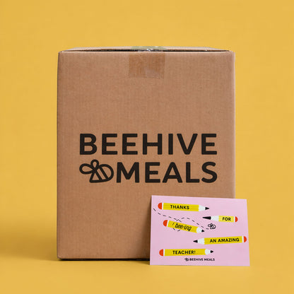 Cardboard box with 'Beehive Meals' branding on a yellow background