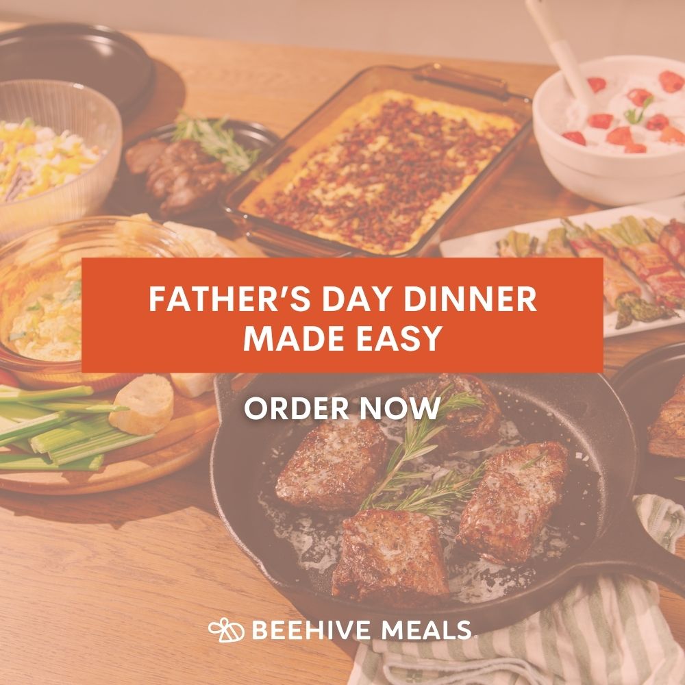 Table with various dishes and a promotional banner for Beehive Meals Father's Day dinner that reads "Father's Day Dinner Made Easy. Order Now." 