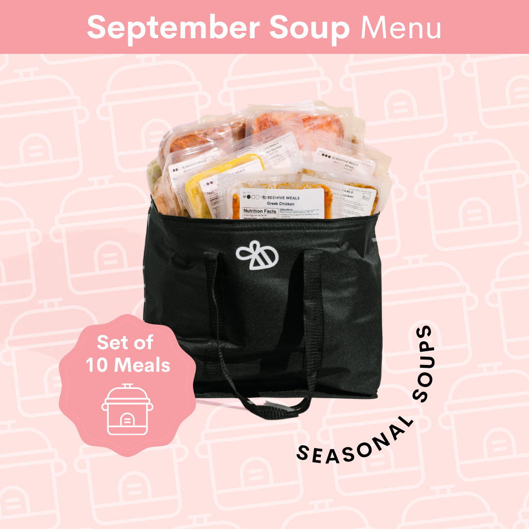 A black insulated Beehive Meals cooler bag filled with packaged soups, shown on a pink patterned background with the text 'September Soup Menu' and 'Set of 10 Meals'.