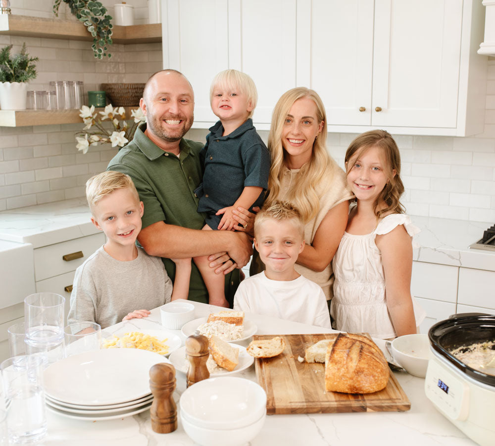 Jackson Family standing in the kitchen cooking Beehive Meals. Allyse Jackson, founder of Beehive Meals. 