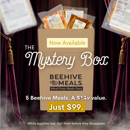 A cardboard box labeled 'BEEHIVE MEALS' with 'Now Available' and 'Just $99.' on a promotional graphic, surrounded by dark purple curtains and floating meal packages.